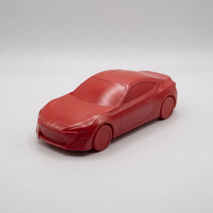 Red 3D-printed car model with a 1k base colour coat, satin and unsealed