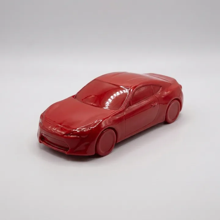 The same red car model under a glossy standard clear coat