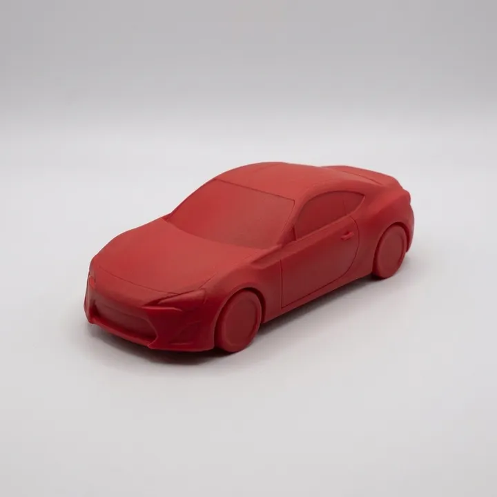 The same red car model under a matte clear coat