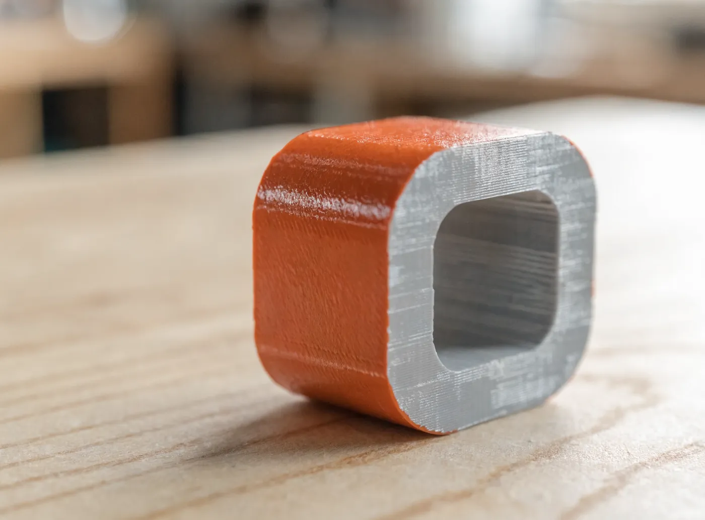 A 3D-printed part painted on the outside with a clean, raw grey internal channel