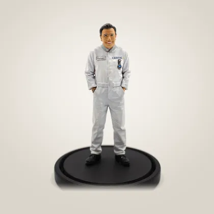 A hand-painted figurine of a smiling man in grey work coveralls, on a black base