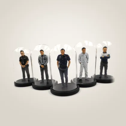 Five figurines of the same man in five different work uniforms, each under its own glass dome