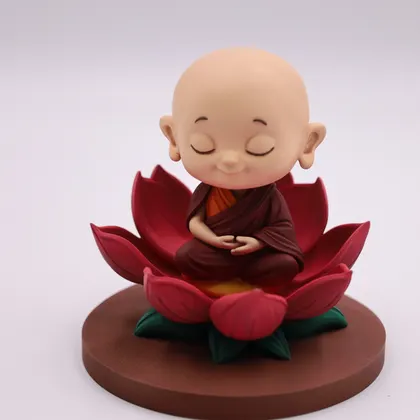 The monk figurine head on, showing the painted face