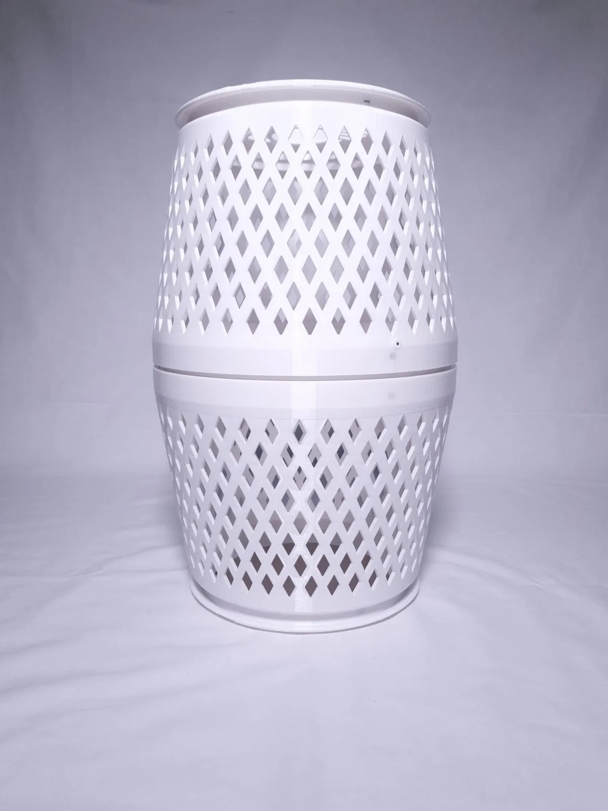 The white purifier unlit on a white backdrop: two diamond-lattice halves joined at a plain central band