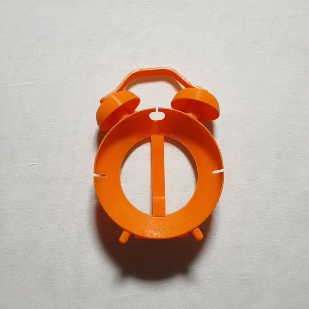 The assembled orange stand without its speaker: the empty ring on its feet, with the handle and two bells on top