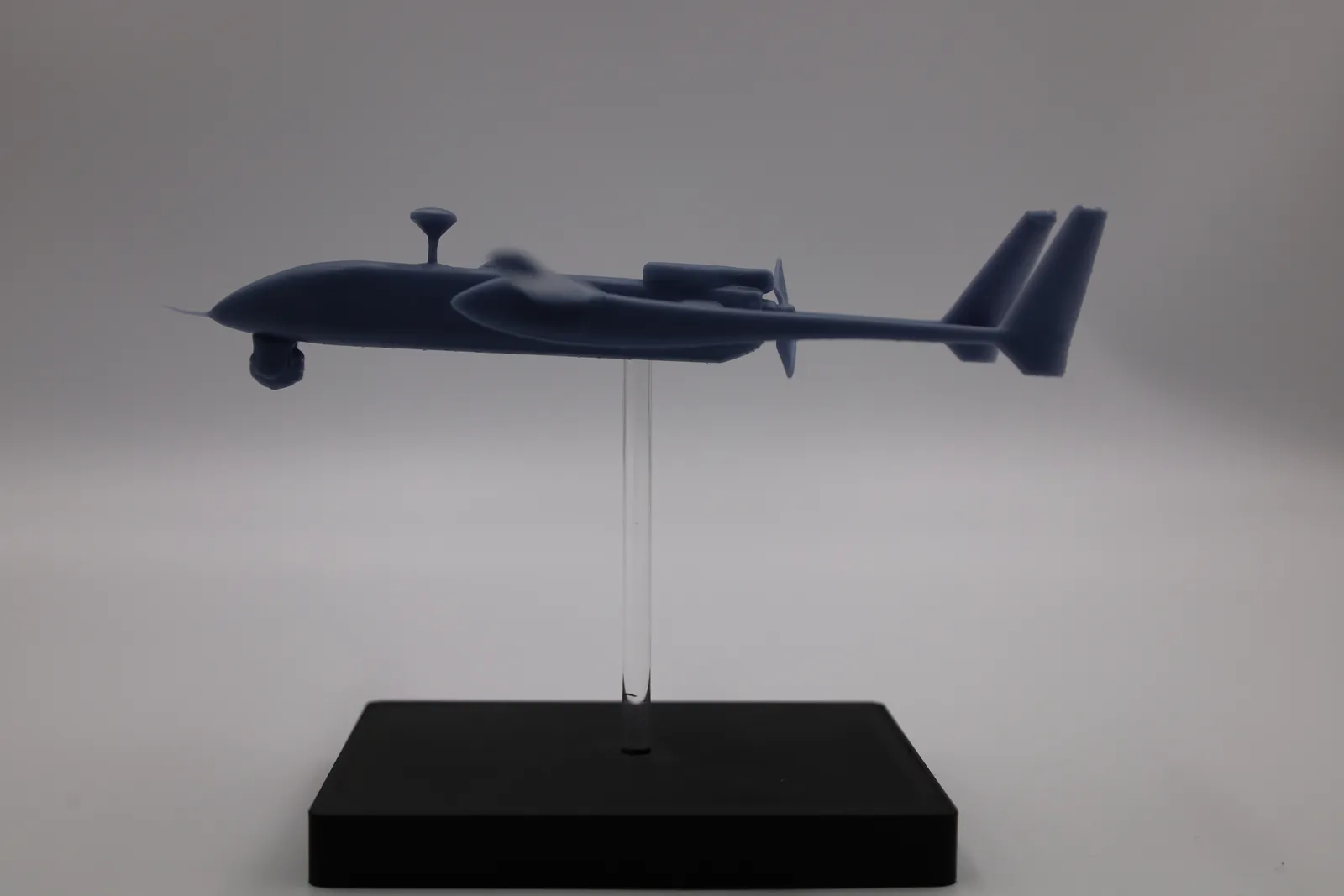 Side view of the finished Heron 1 model: the nose probe, the sensor ball under the nose, the antenna mast and the twin tail fins