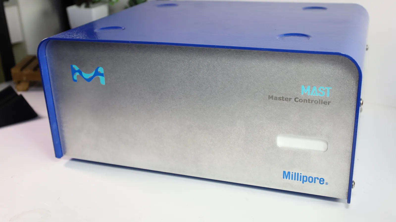 The finished Master Controller replica from the front: silver front plate with Merck's logo and MAST Master Controller lettering in a blue enclosure
