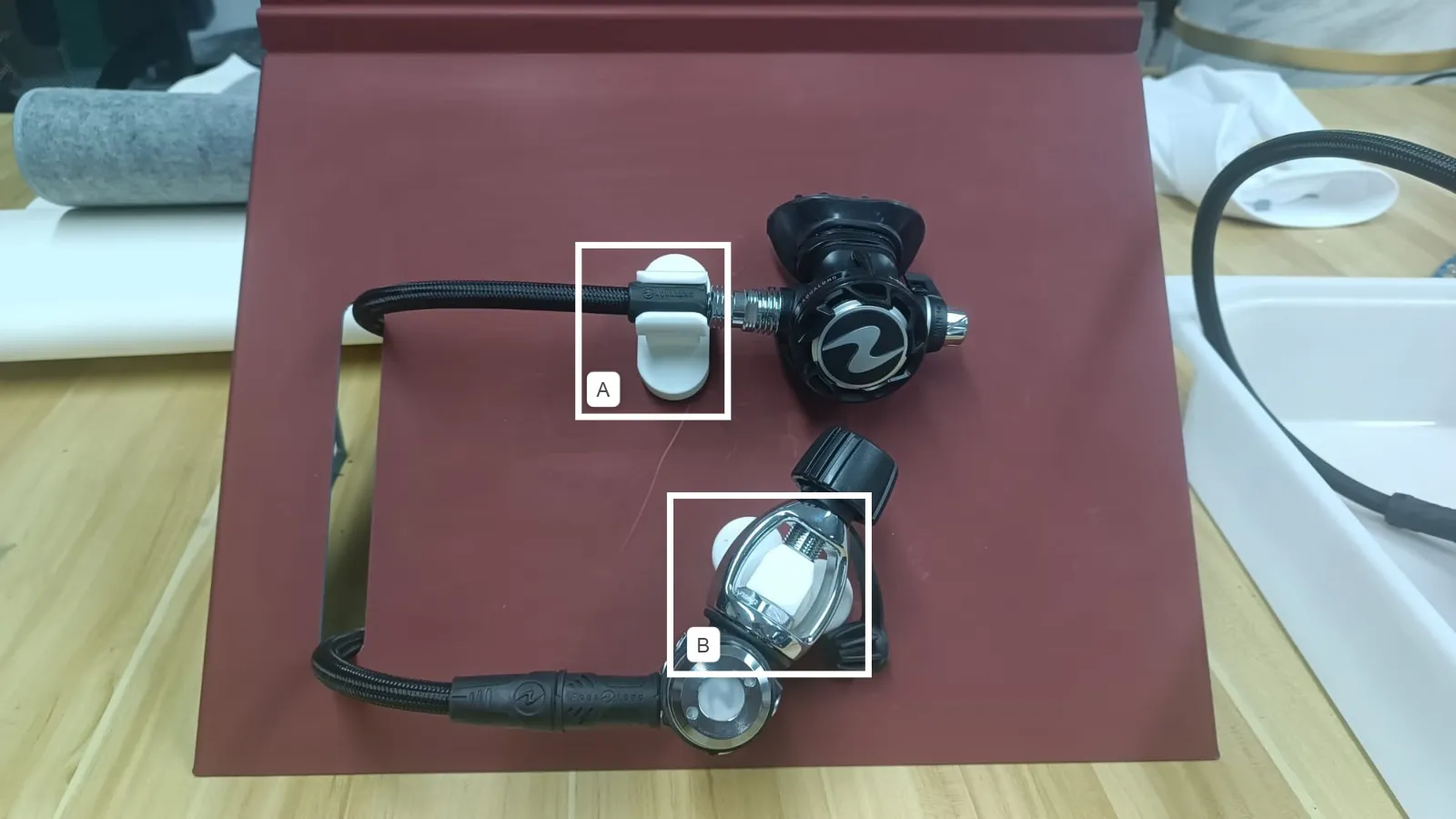 A regulator on a maroon sample panel, with holders A and B boxed and labelled