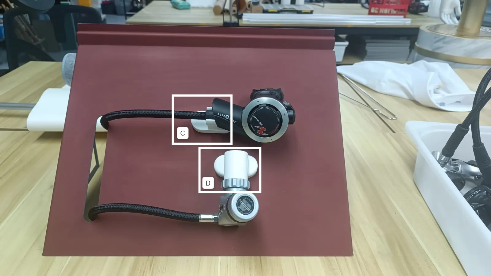 A regulator on the maroon sample panel, with holders C and D boxed and labelled