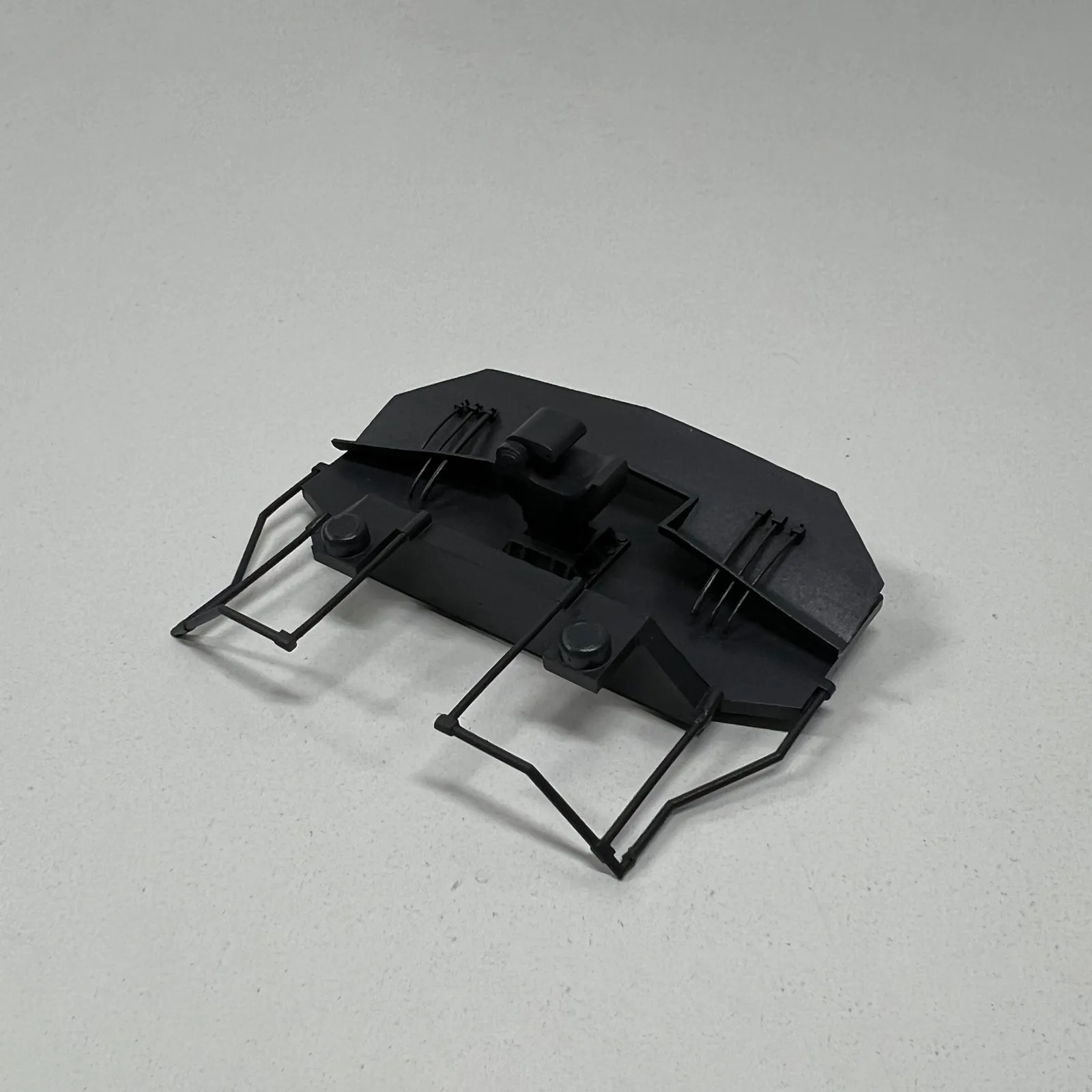 The locomotive's printed front pilot in dark grey, with thin grab rails and steps