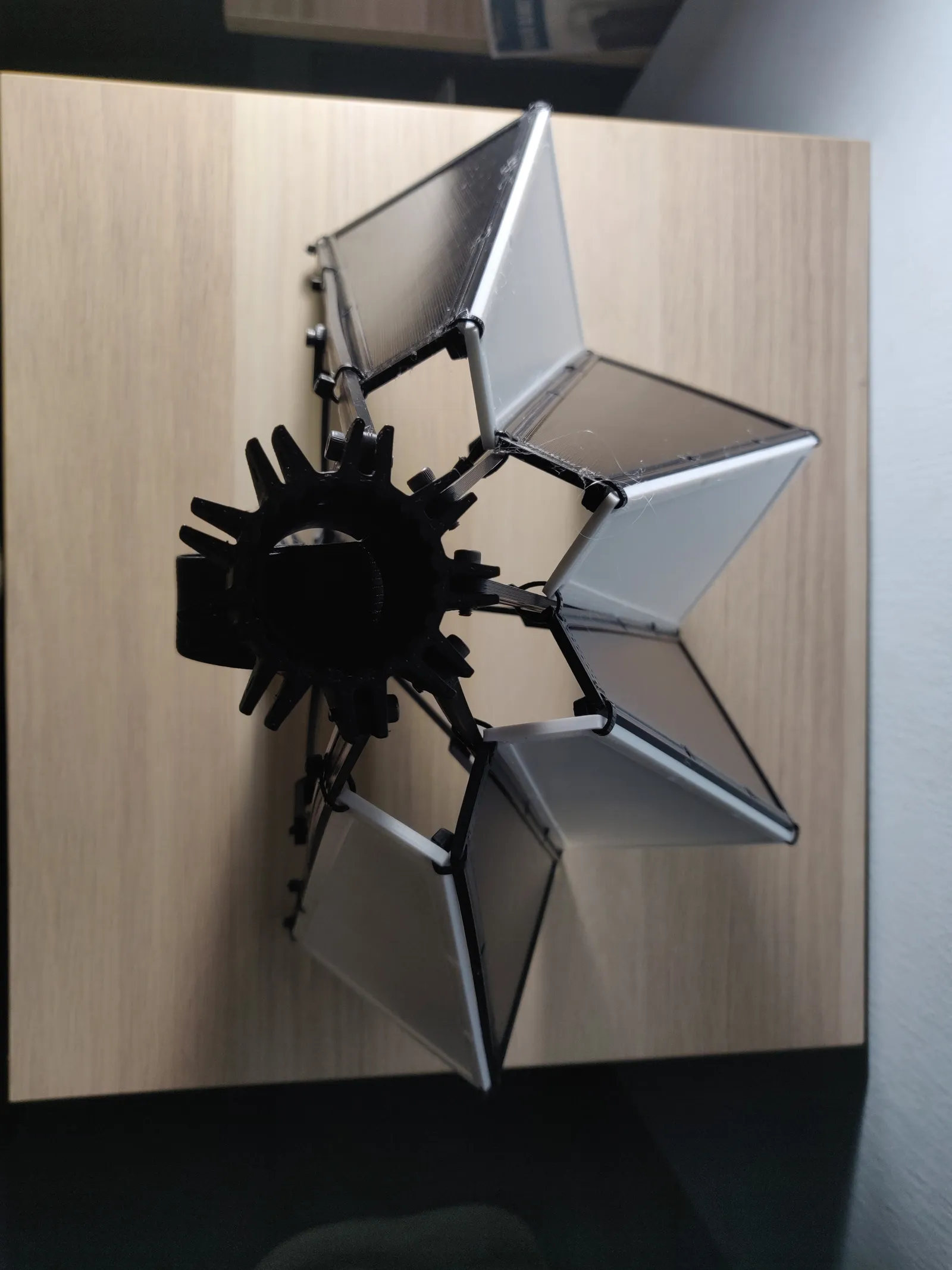 Looking down on the prototype: the black geared hub in the middle and the hinged panels fanned out around it
