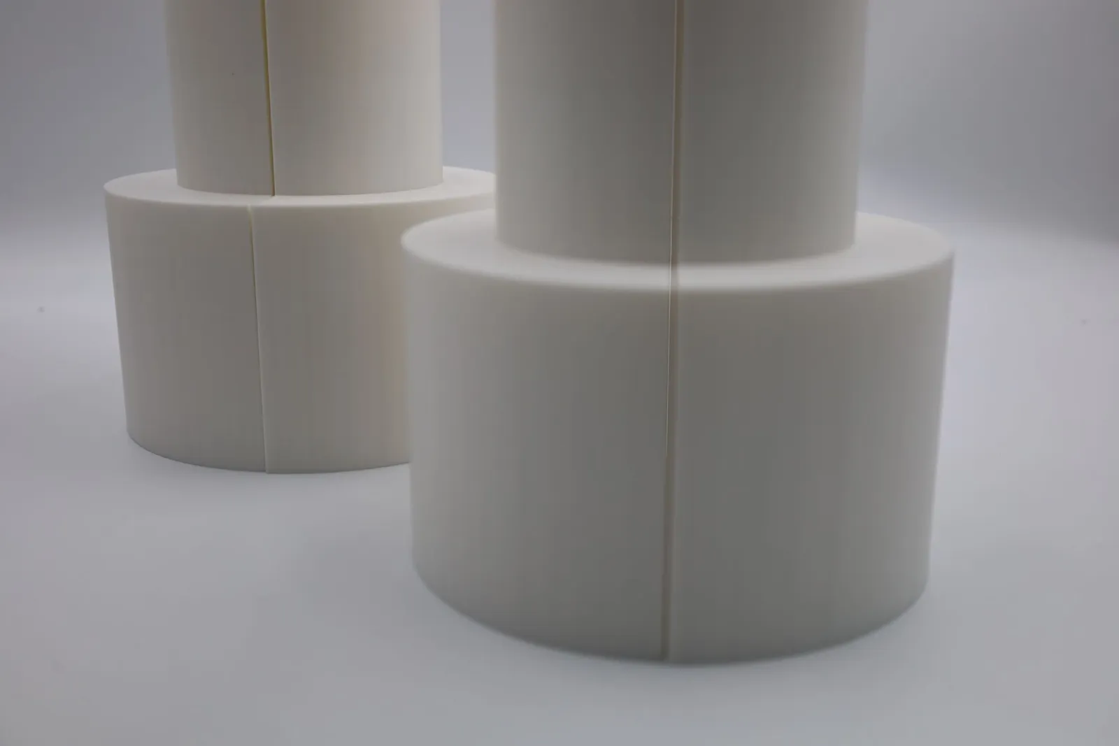 Close view of the round bases of the two finished bagel moulds, with the seam where the halves meet running up each one
