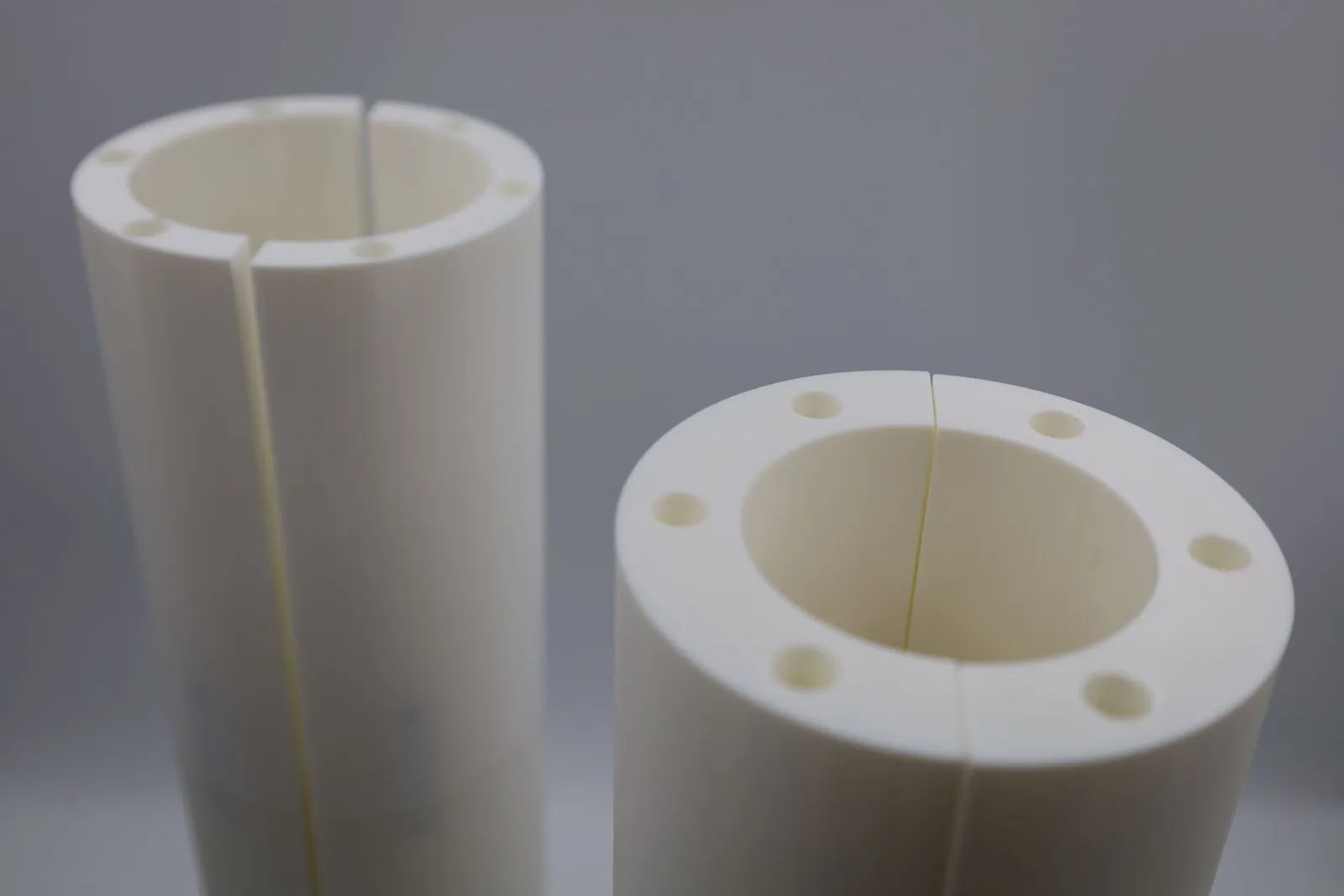 The tops of two joined bagel moulds, each with six screw holes around the rim and a fine seam where the halves meet