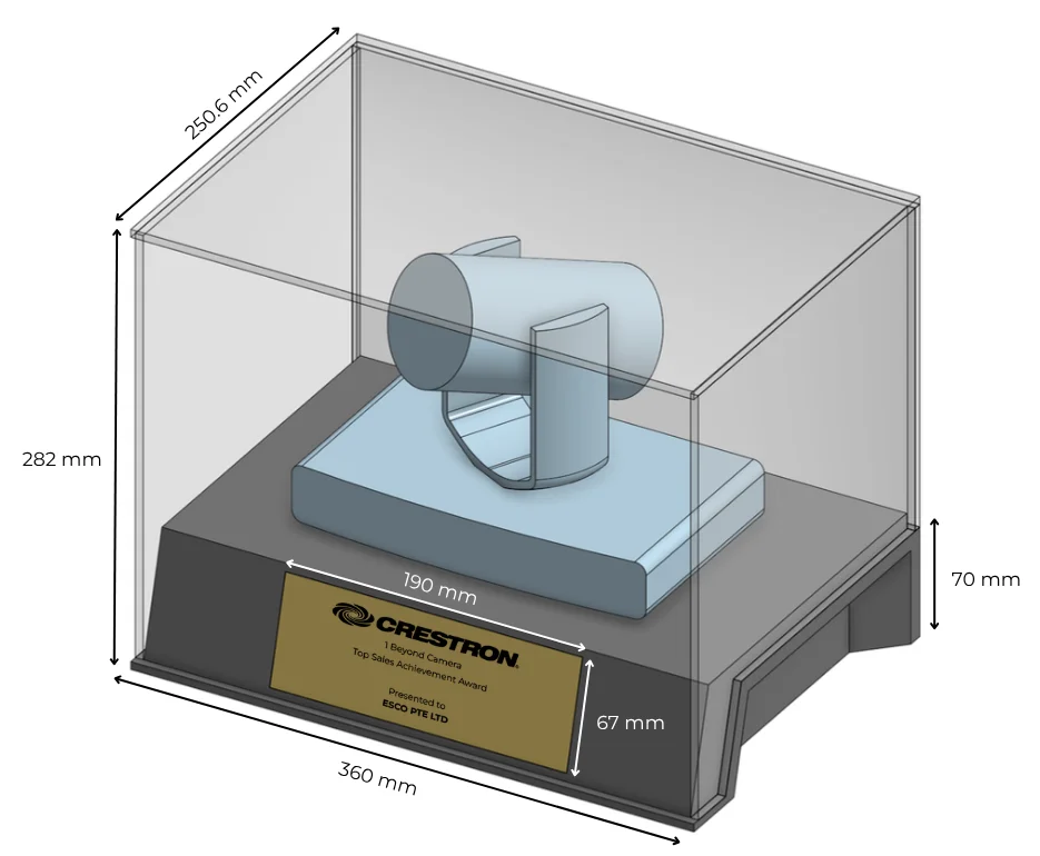 Render of the first design: the camera on a black base with a gold nameplate, inside a clear acrylic case 360 mm wide and 282 mm high