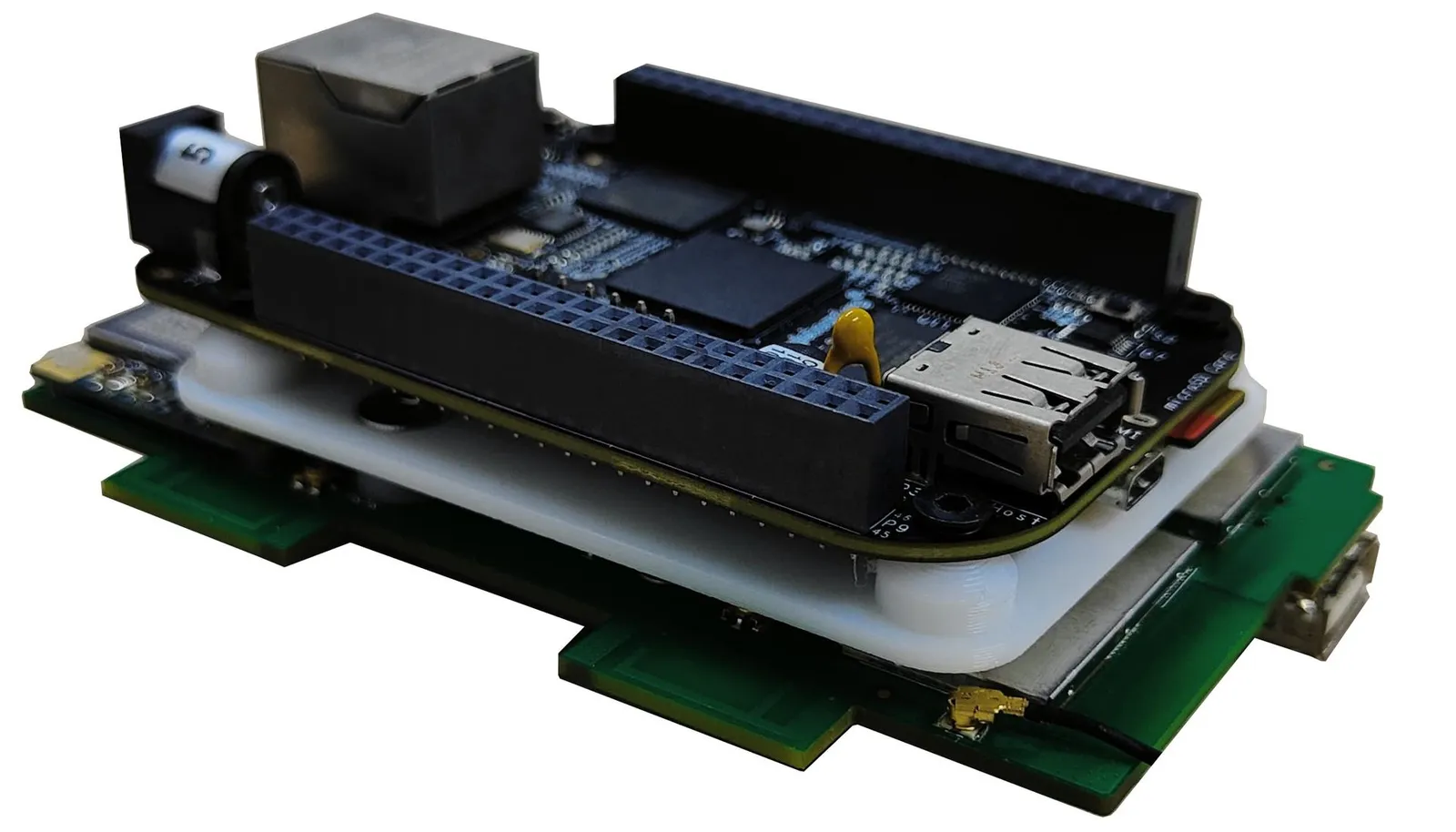 Close-up of the BeagleBone board stack with a white printed brace sandwiched between the boards