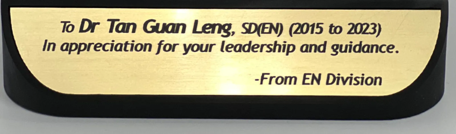 Close-up of the brushed gold plate: To Dr Tan Guan Leng, SD(EN) (2015 to 2023), In appreciation for your leadership and guidance, From EN Division