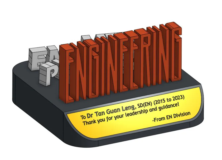 Revision 0 render: ENGINEERING in orange standing on a flat black deck, white abbreviations scattered behind it and a gold plate on the curved front