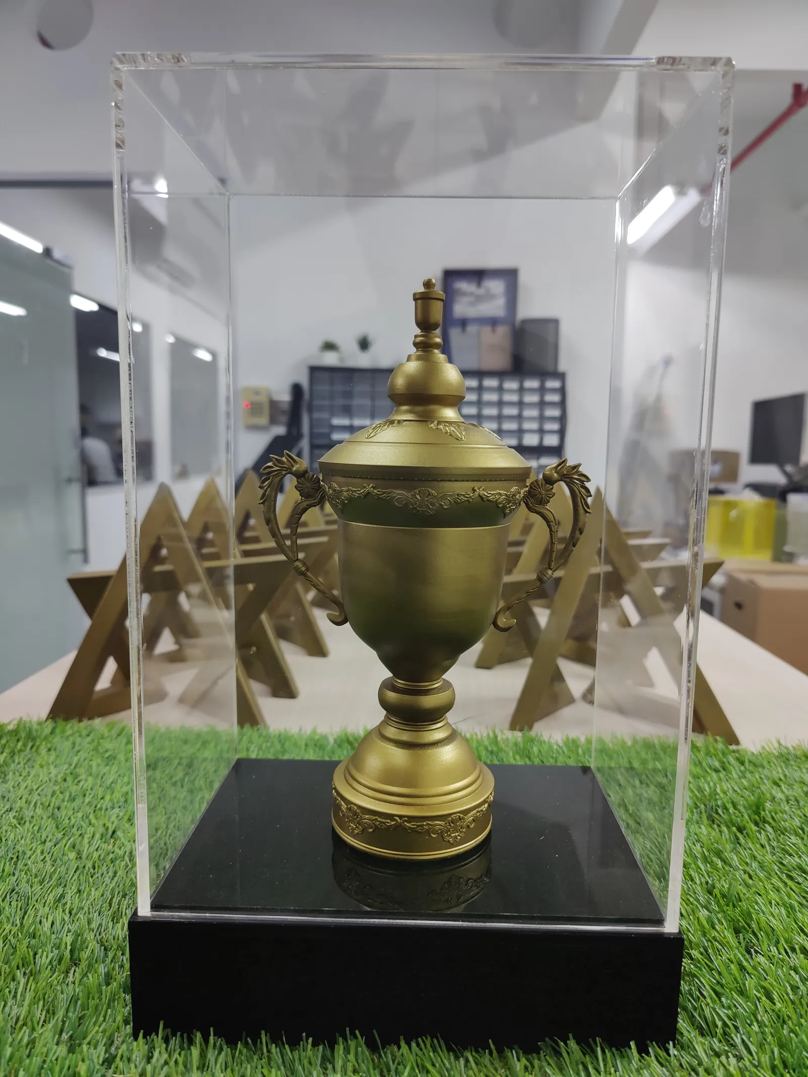 The finished Congress Cup replica inside its clear acrylic case on a black base