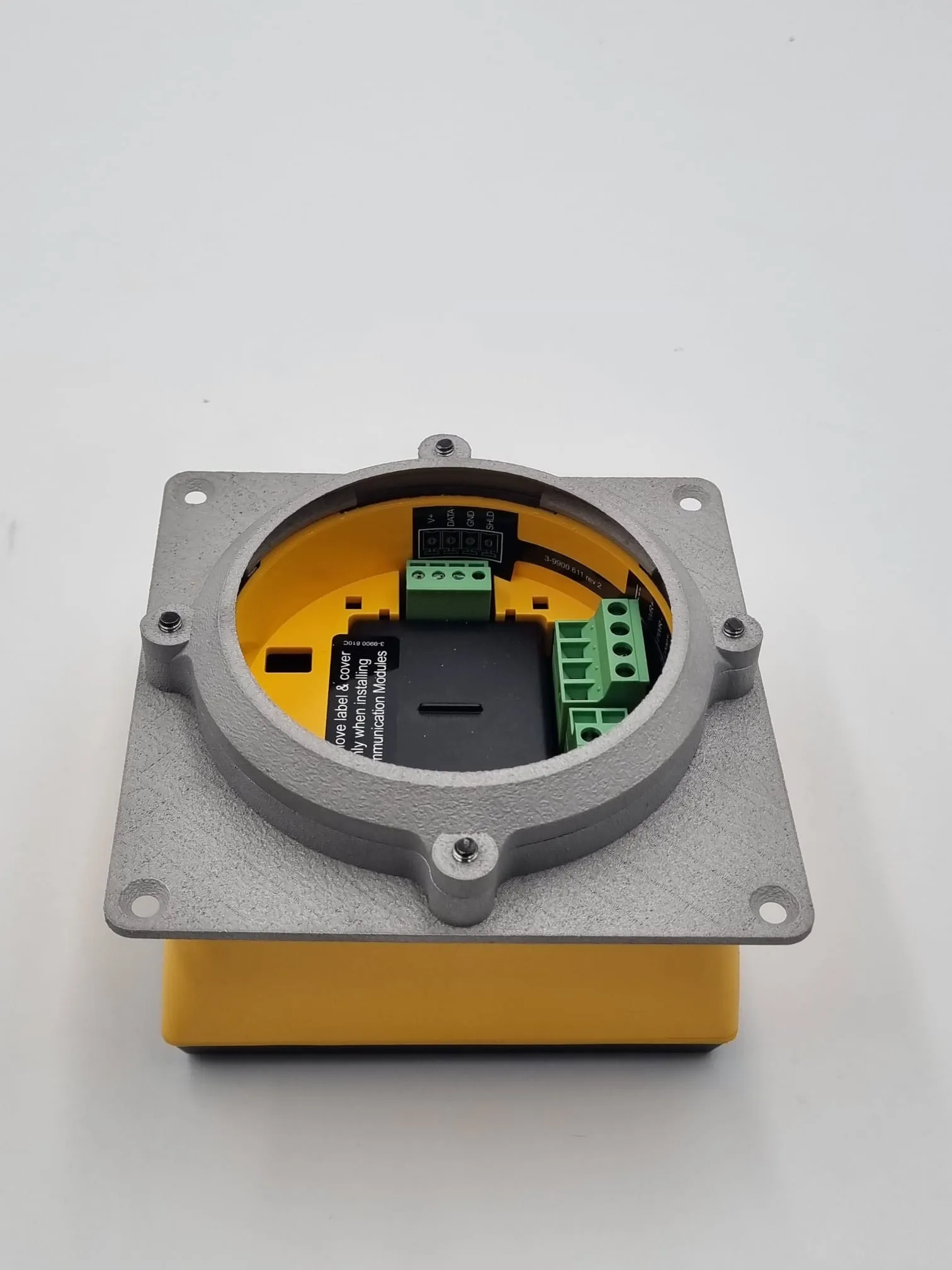 The back of the fitted meter seen through the aluminium collar, with the green wiring terminals reachable inside