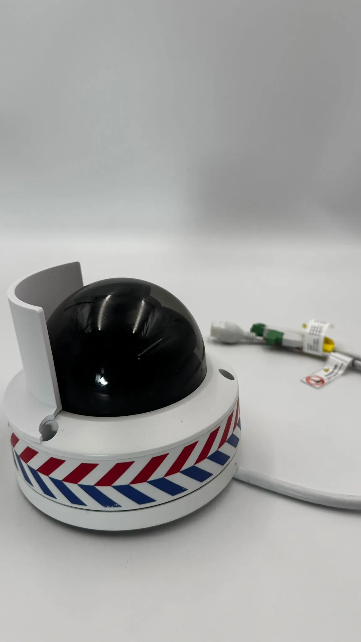 The camera at a low angle with the white shield rising behind the black dome on the far side