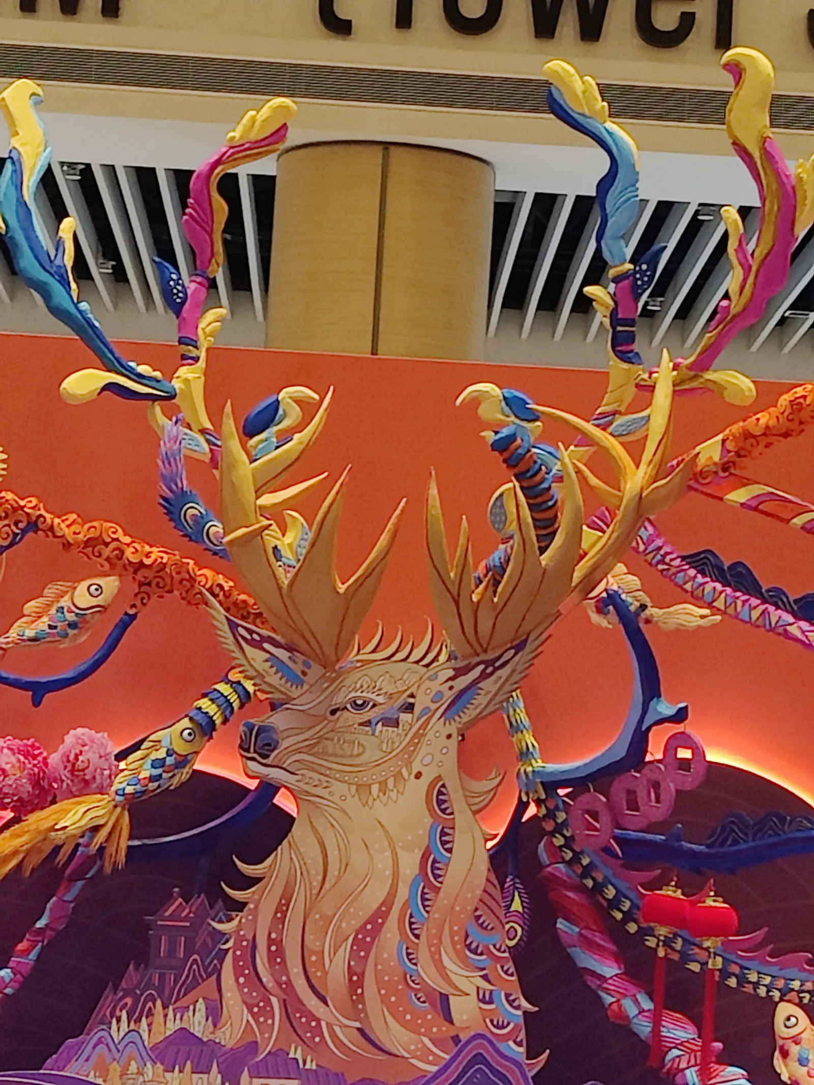 Looking up at the painted stag on the backdrop, crowned by the 3D printed antlers