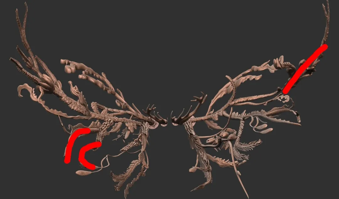 The sculpt shaded in copper, with red marks on a curled lower branch and one upper tip