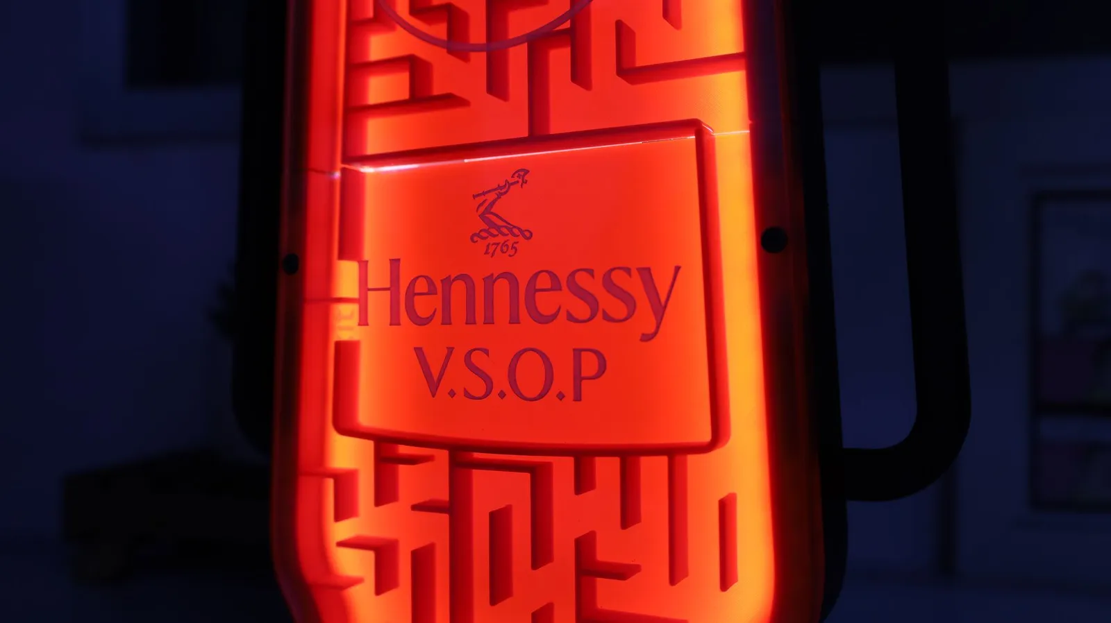 Close-up of the logo panel with the LEDs on, the maze glowing red around the Hennessy V.S.O.P lettering
