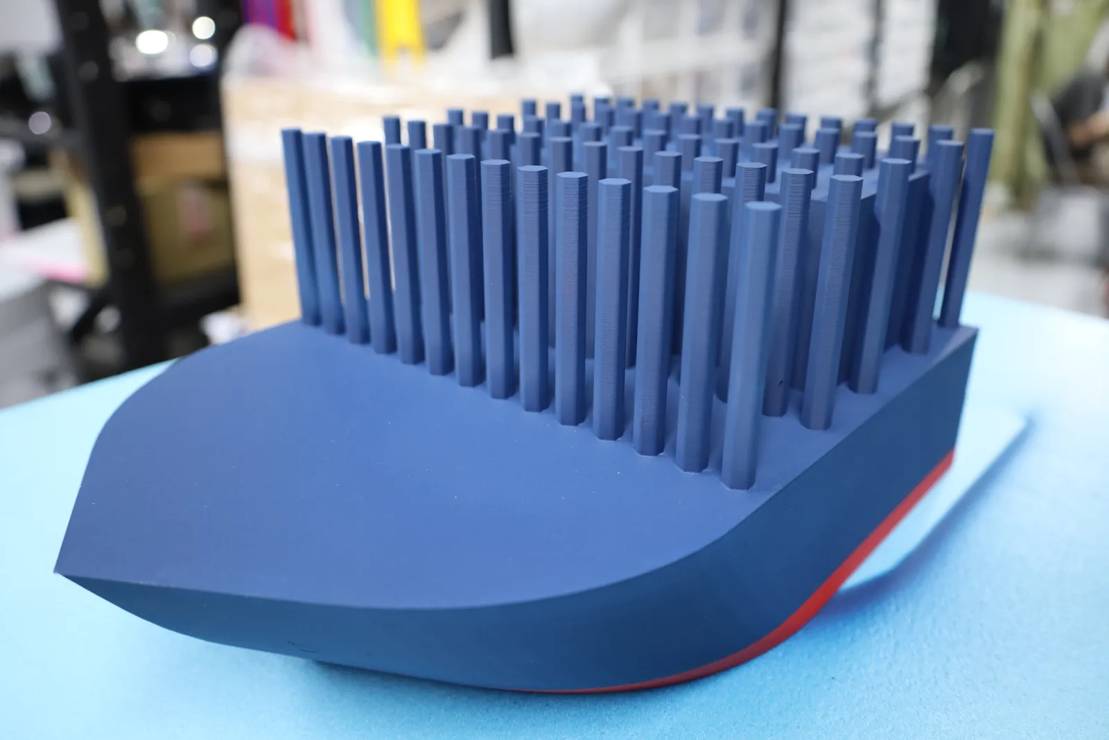 The bare navy hull from the bow, with rows of pegs standing up along the deck before the containers go on