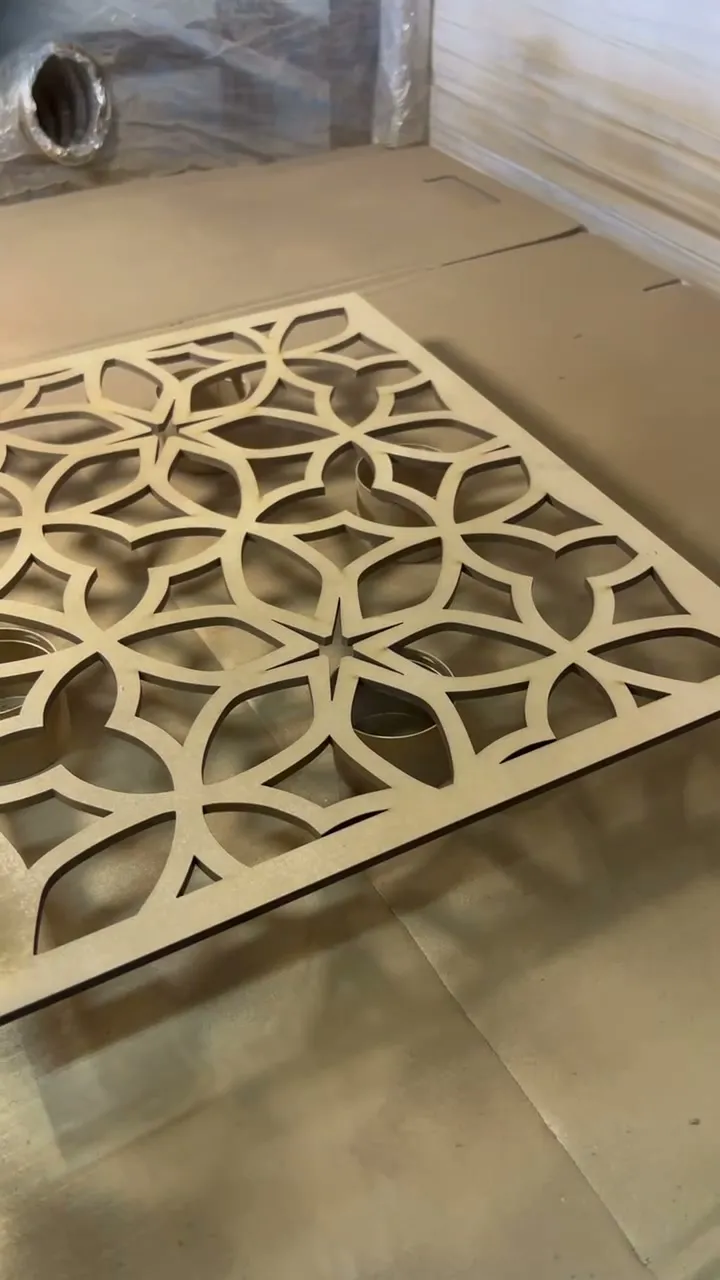 The petal pattern panel fully sprayed gold, drying on the booth floor