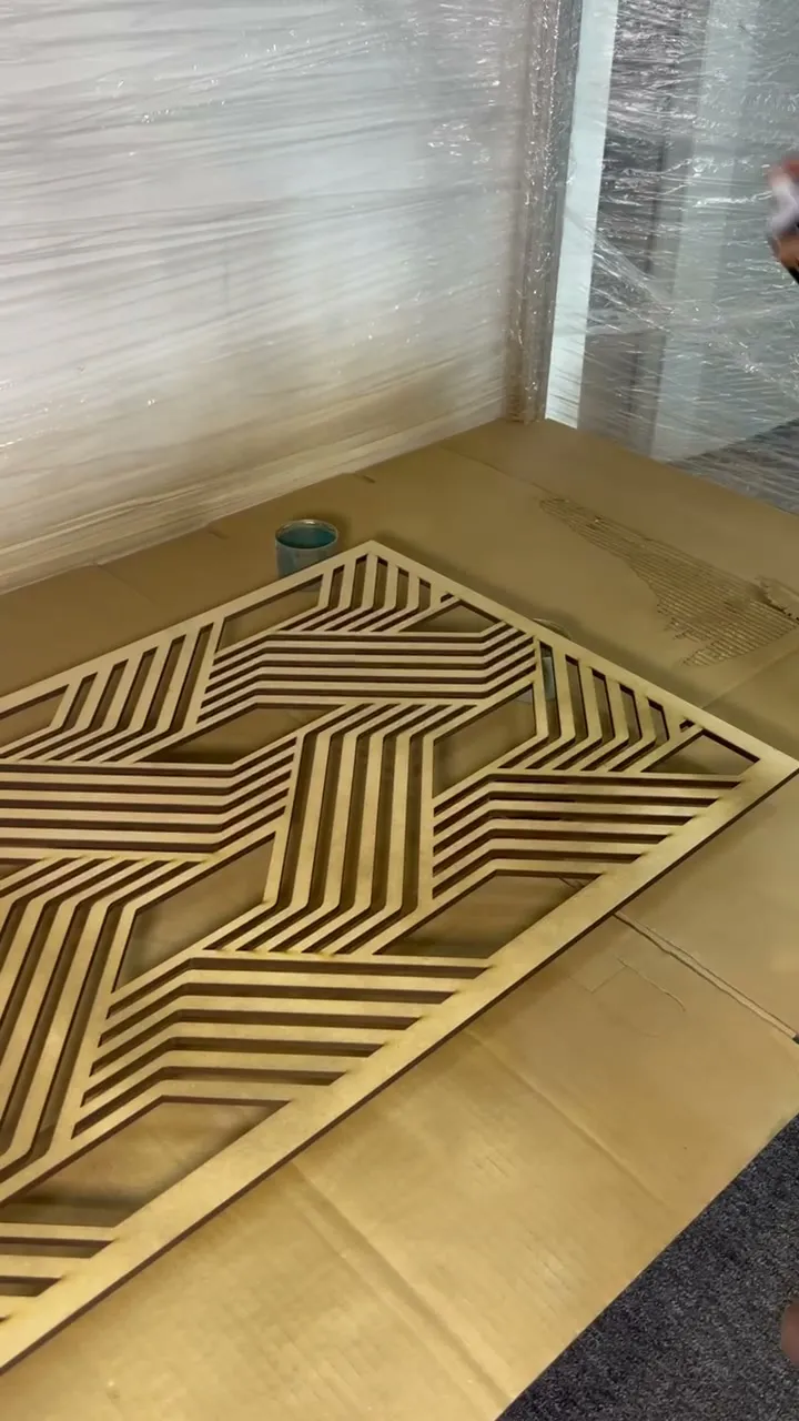The diagonal stripe panel finished in gold, lying in the spray booth