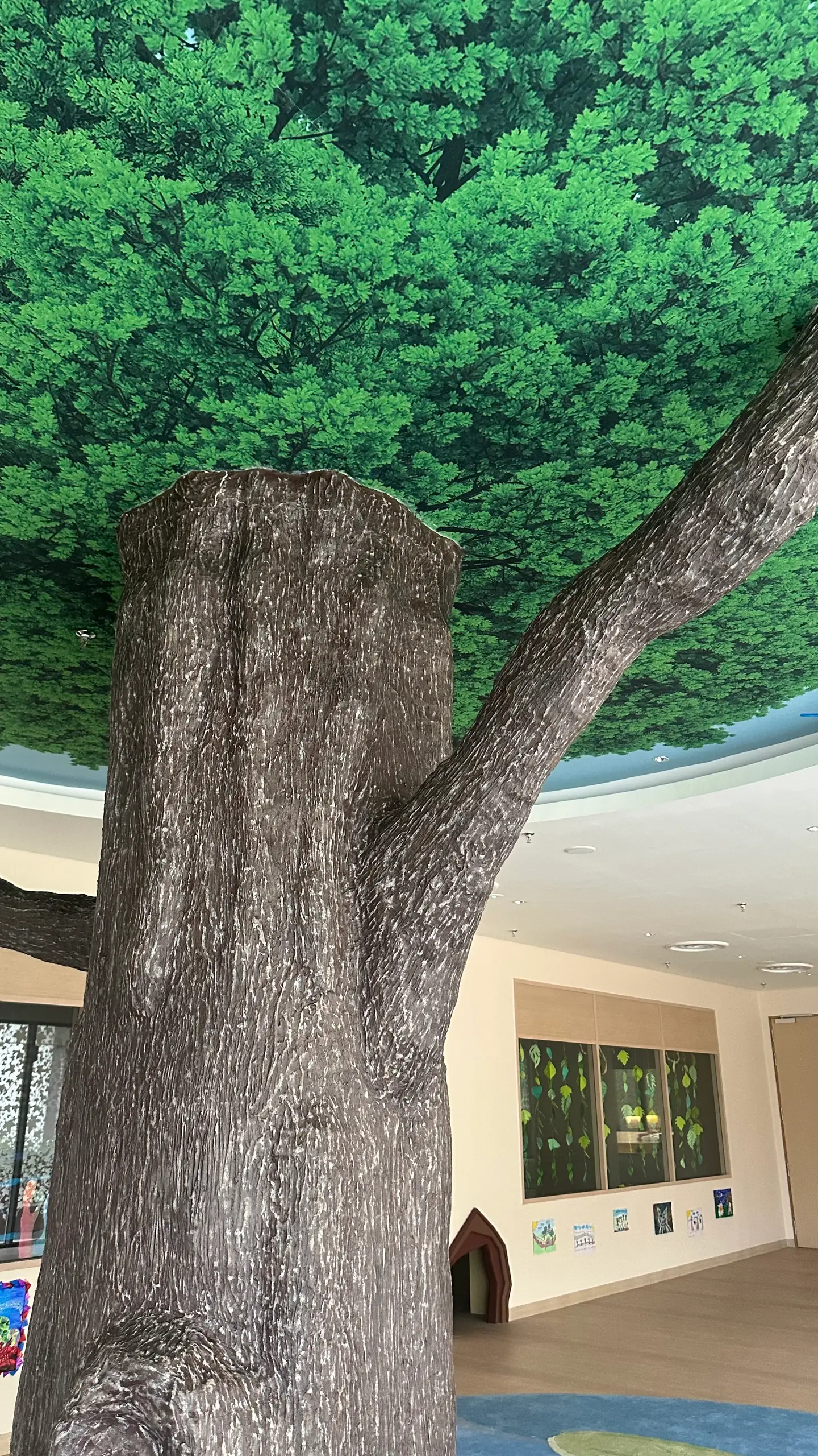 Looking up the finished Zoo School trunk to its two branches and the green canopy mural