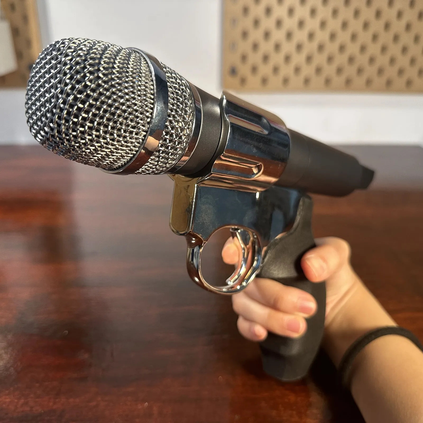 Close view of the mirror chrome cylinder ring wrapped round the microphone just below its grille