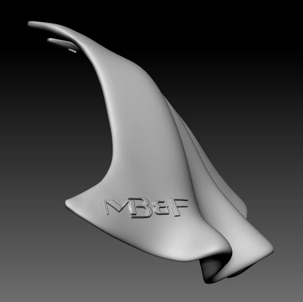 Grey render of the cape from the side, its lower edge flattened so the debossed MB&F logo sits on a flat face