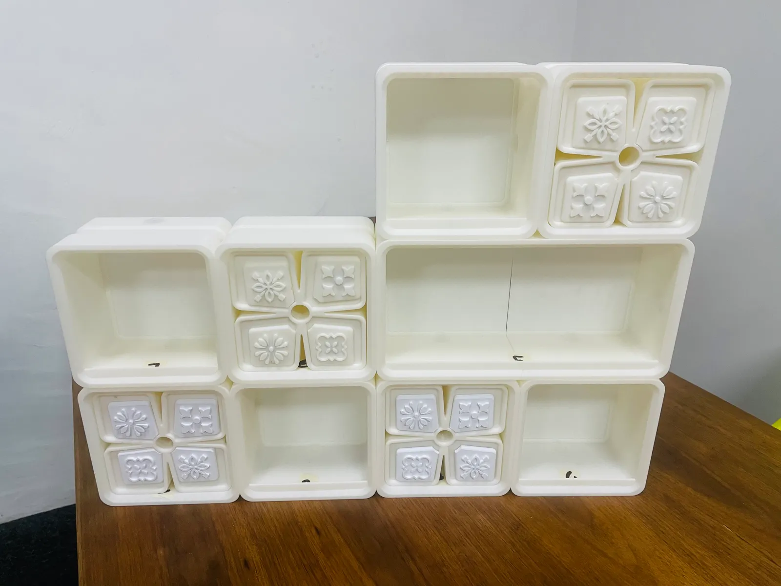 The finished set from a low front corner, showing the depth of the open boxes and the raised relief tiles on the four tiled fronts