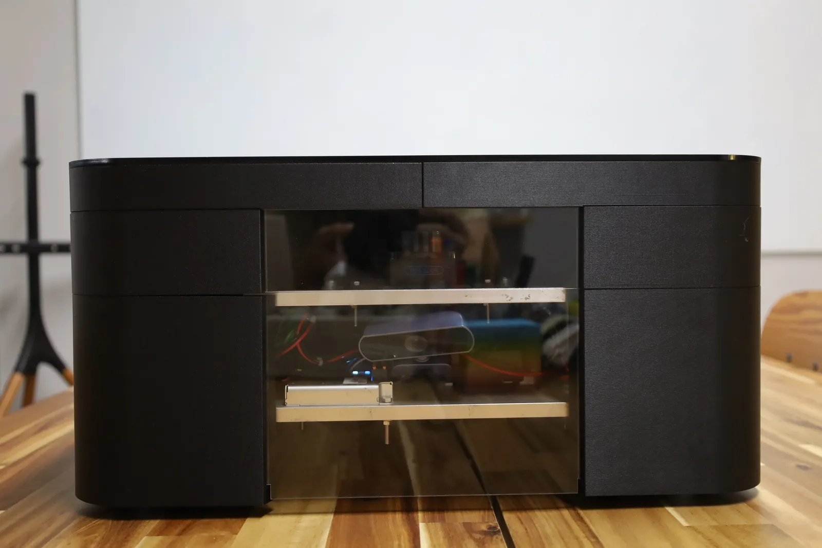 The front of the covered AGV head-on: a clear acrylic panel shows the LiDAR and the camera on their shelves inside