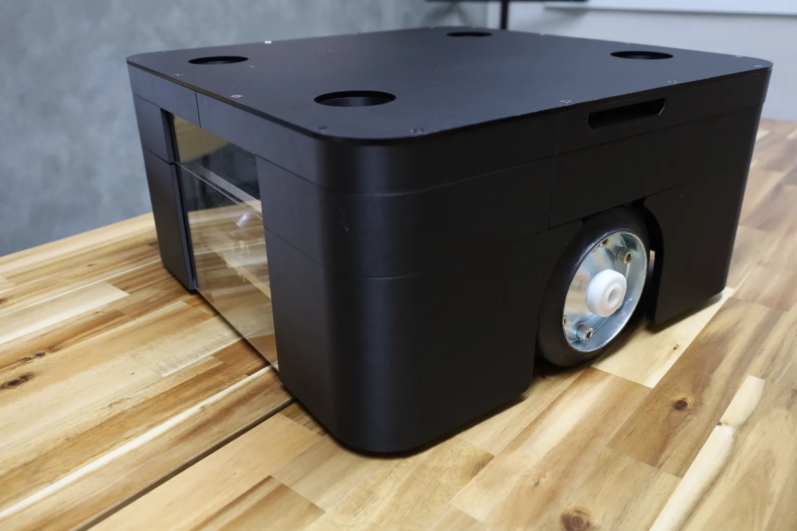 The cover from a front corner: clear acrylic across the front, the skirt coming down low over the drive wheel