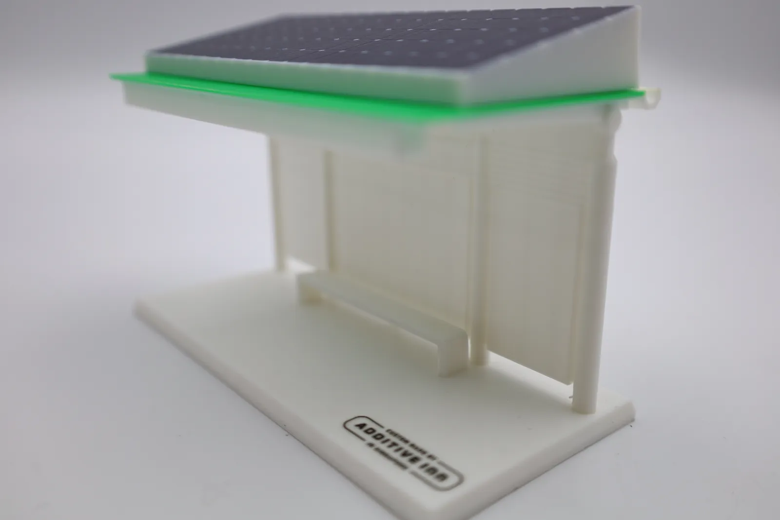 The finished model from the right: the sloped solar roof over the green roof plate, the gutter end, white walls and the bench