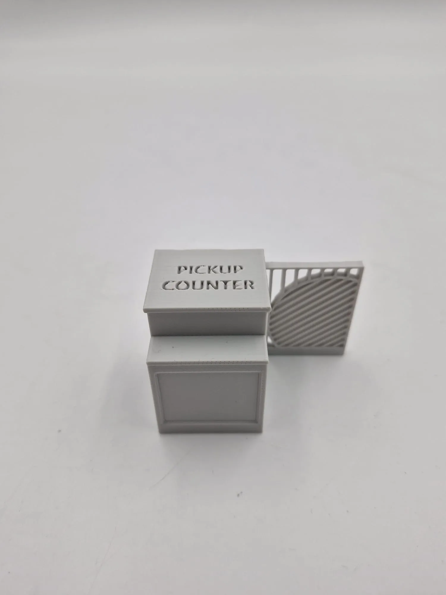 The modified pickup counter in grey, with a slatted divider screen joined to its side