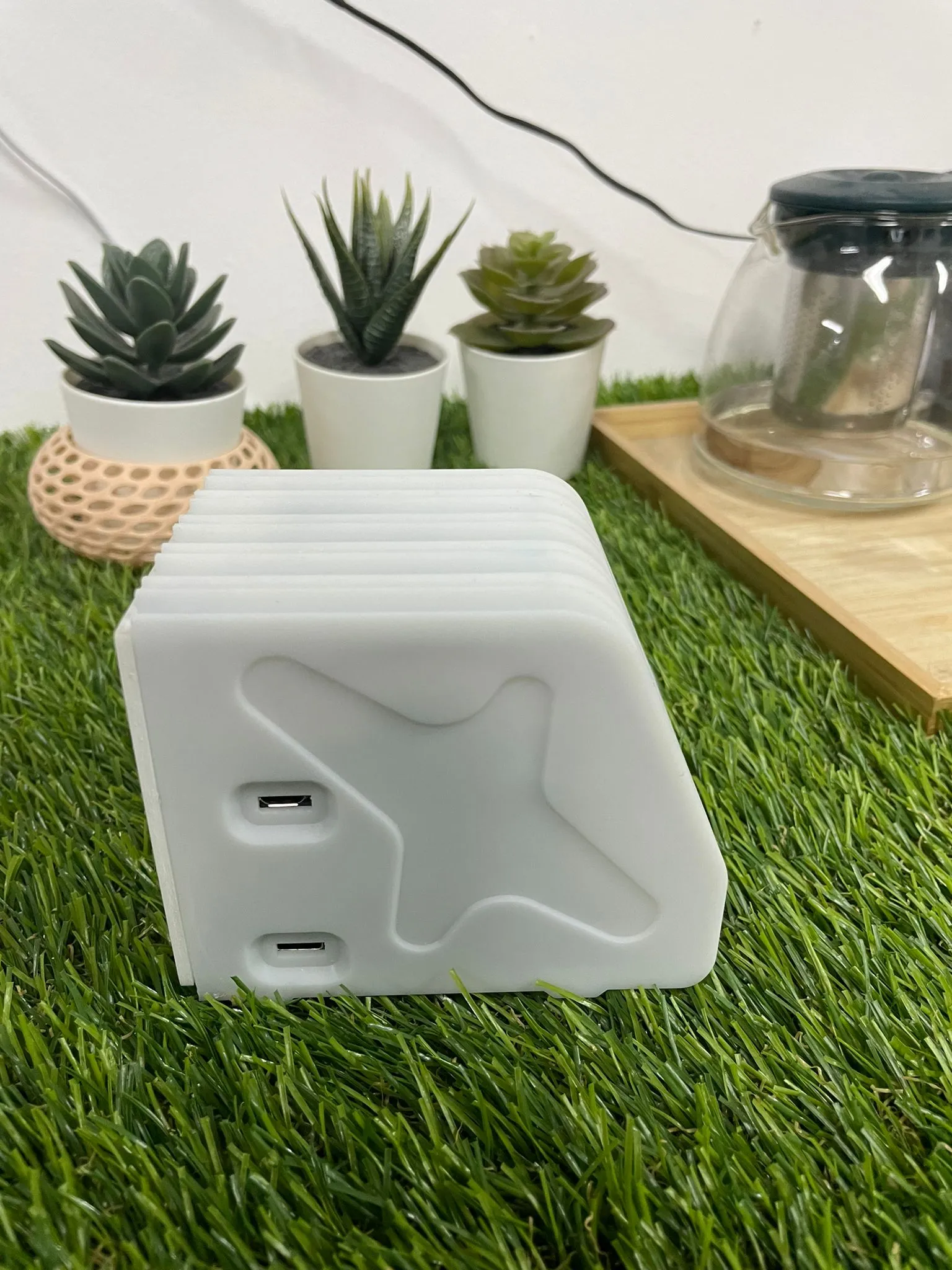 The finished enclosure from a corner: the embossed aeroplane and two USB openings on the side, with the cooling fins running across the top