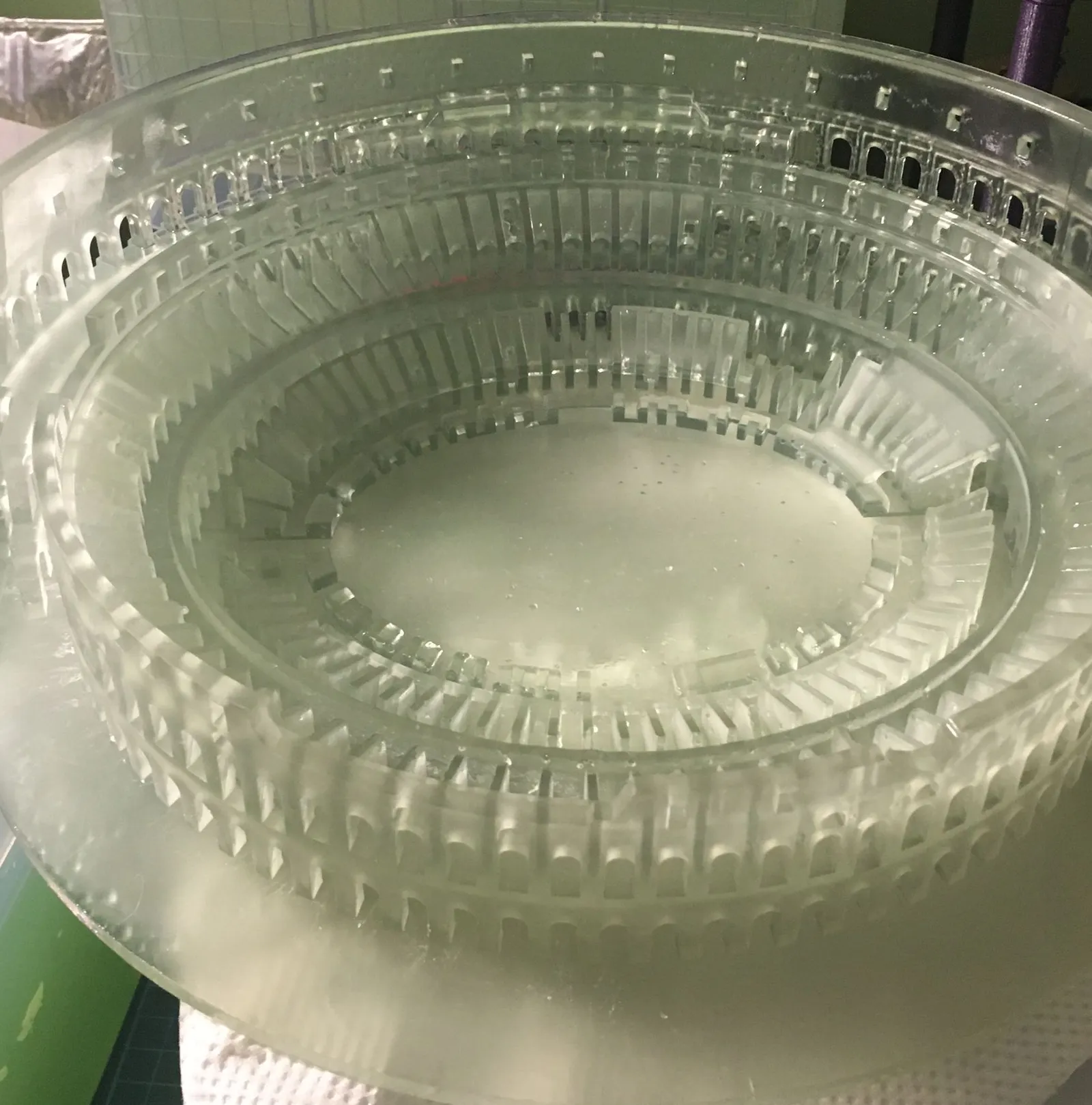 The clear Colosseum on its round base after the supports were removed, looking across the seating tiers to the arena floor