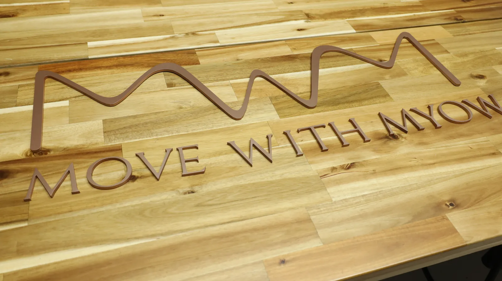 All the rose gold pieces laid out on a wooden table in our studio before installation, in their final positions