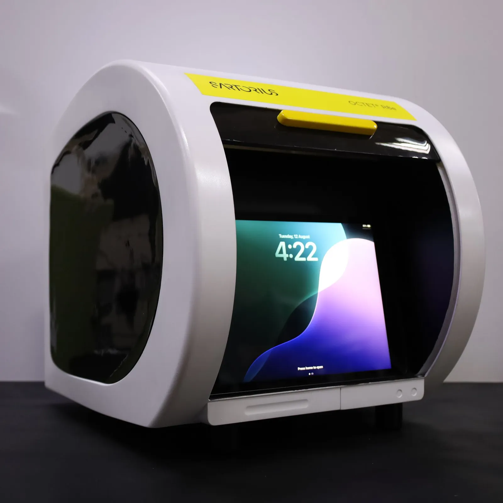 The Octet R8e model at an angle, its rounded white body and tinted curved door with a screen lit behind it