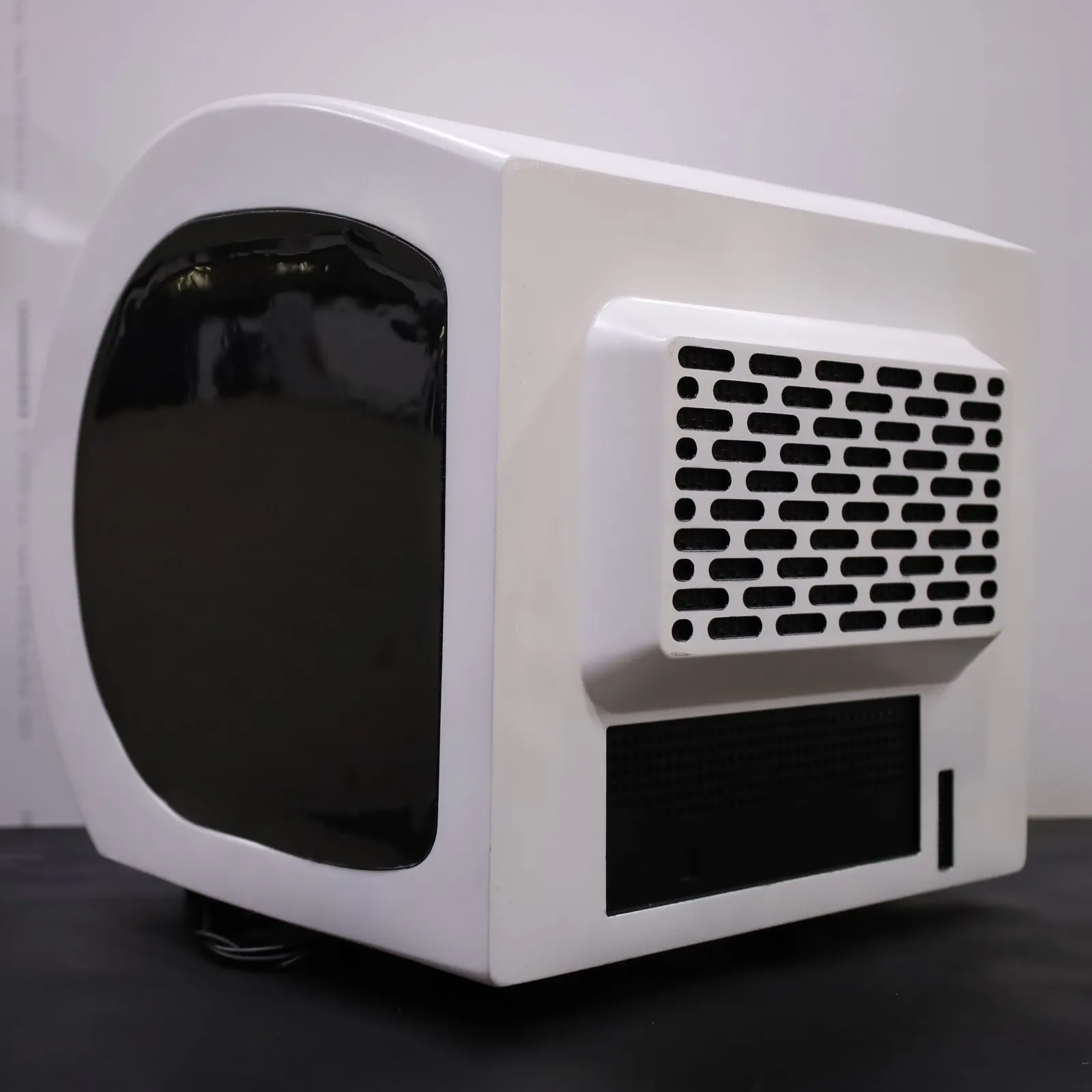The Octet R8e model from the side and back, showing the vent grille and the dark panel below it