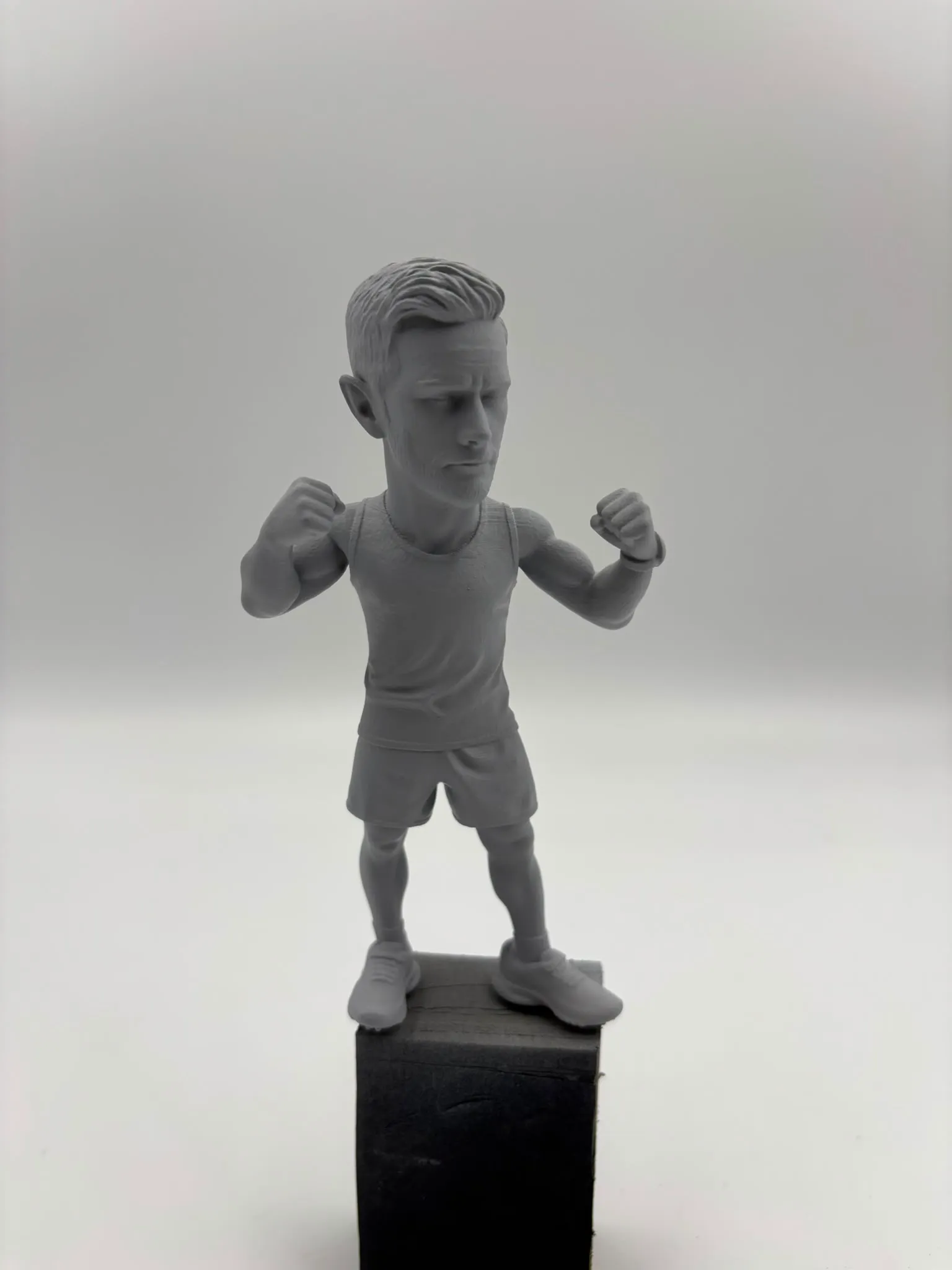 The figure in grey primer on a holding block, before any colour went on