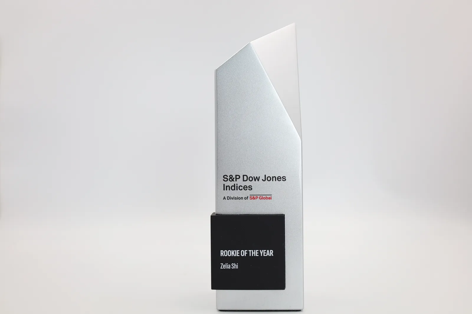 Side view of a finished Rookie of the Year trophy, showing the angled cut across the top of the silver column