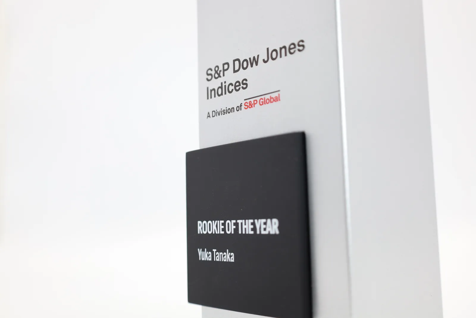 Close-up of a black plate reading ROOKIE OF THE YEAR, Yuka Tanaka, below the S&P Dow Jones Indices logo
