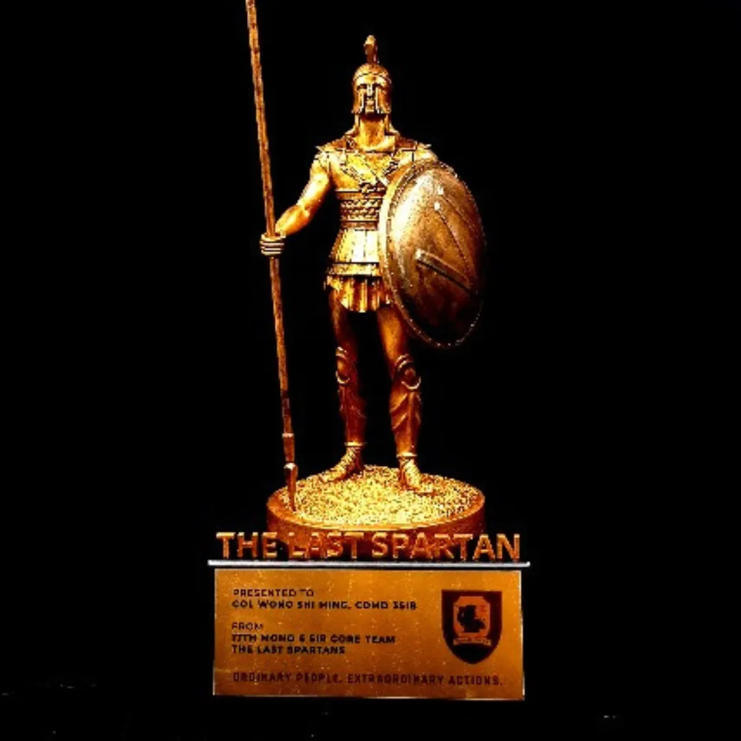 A finished Spartan trophy on a black background, its plate presented to COL Wong Shi Ming, Comd 3SIB, from the 17th Mono 6 SIR core team