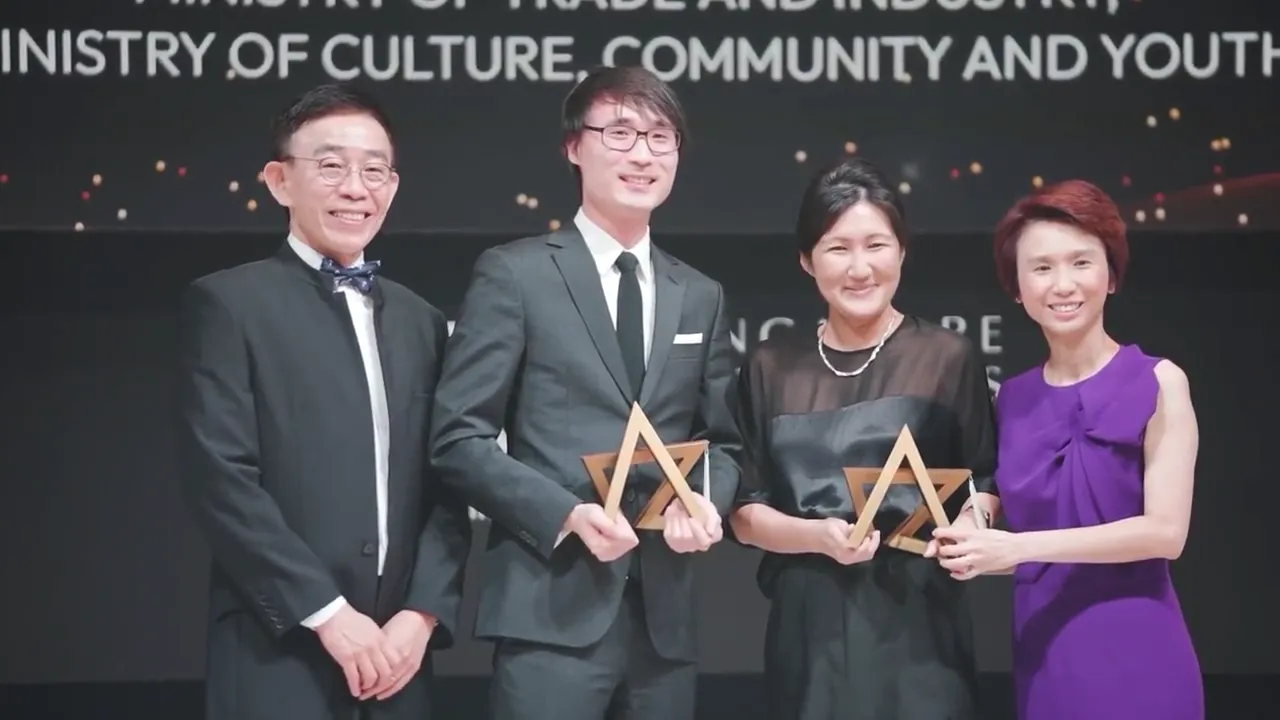 Award winners on stage at the SRA Retail Awards gala dinner 2022, two of them holding gold stars