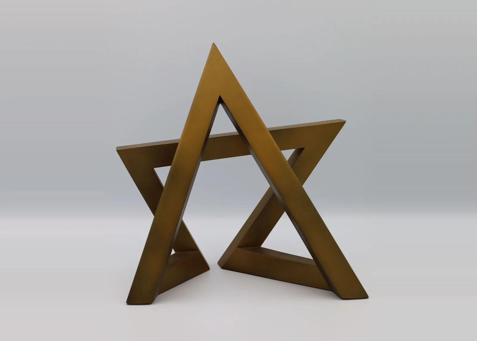 The finished SRA star trophy: two gold triangles interlocked into a six-pointed star, standing on its own points