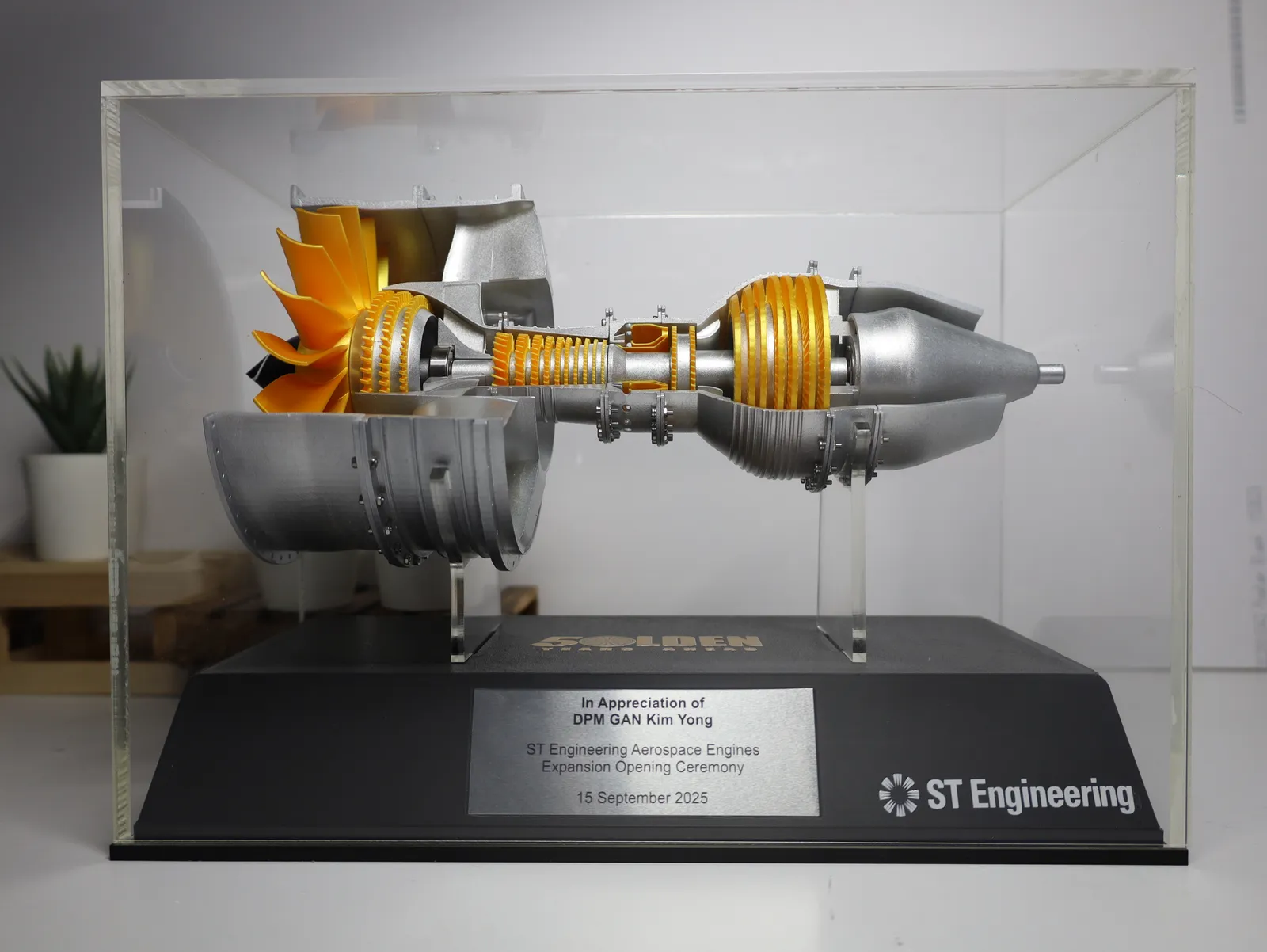 The finished engine and base inside its clear acrylic case